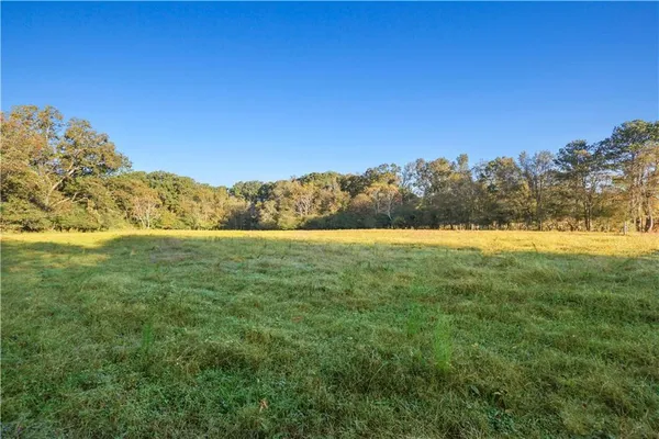 a view of a house with a tree in the background