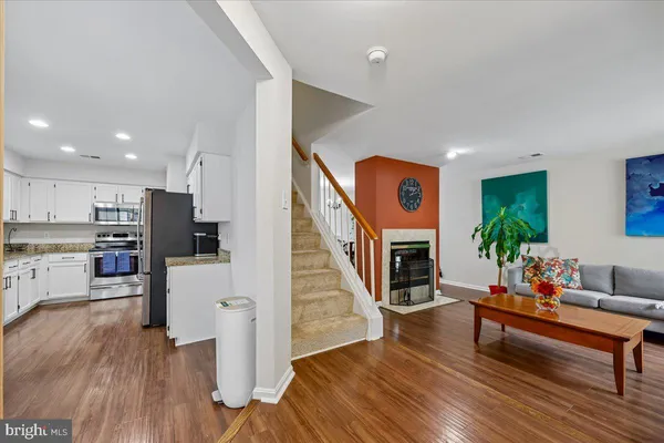 a living room with furniture fireplace and wooden floor