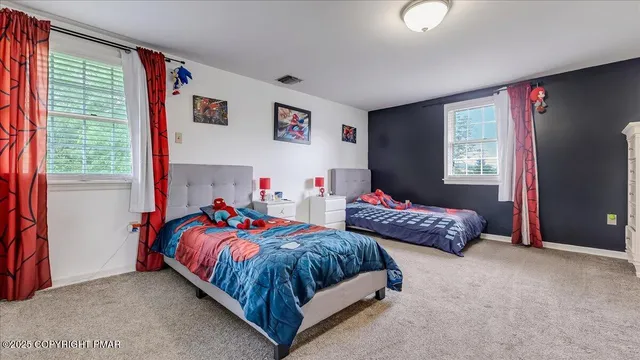 a bedroom with a bed and a dresser in it