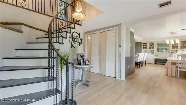 a view of entryway livingroom and hall with wooden floor