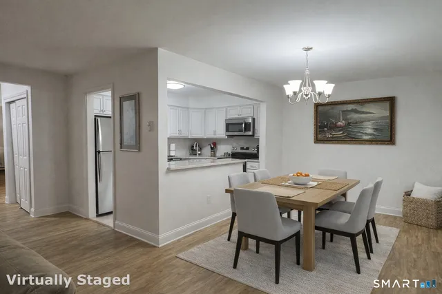 a view of a dining room with furniture and wooden floor