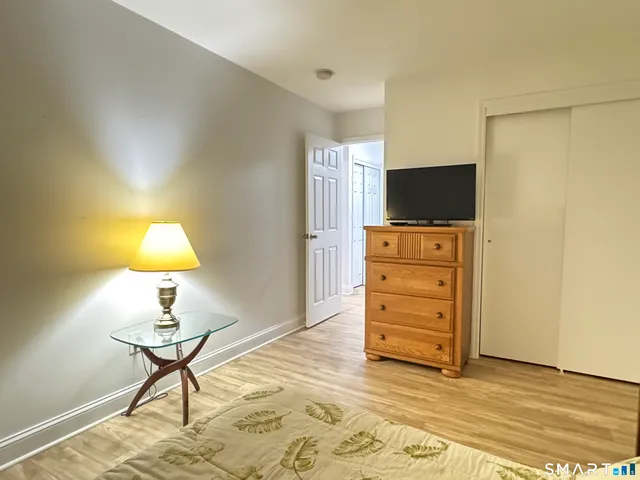 a large bed sitting in a bedroom next to a cabinet