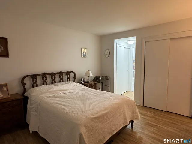 a bedroom with a bed and a night stand