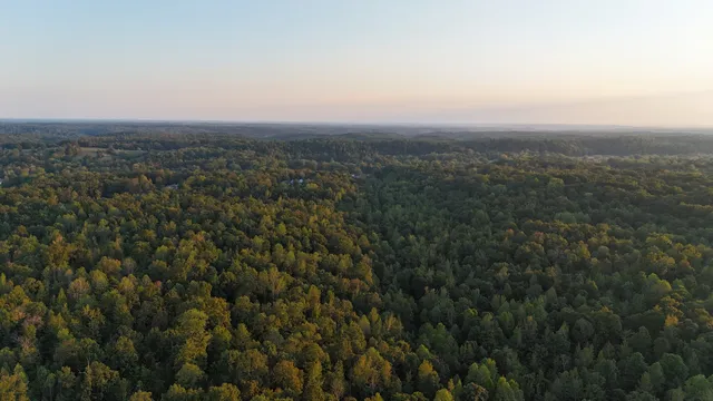 an aerial view of house with yard and mountain view in back