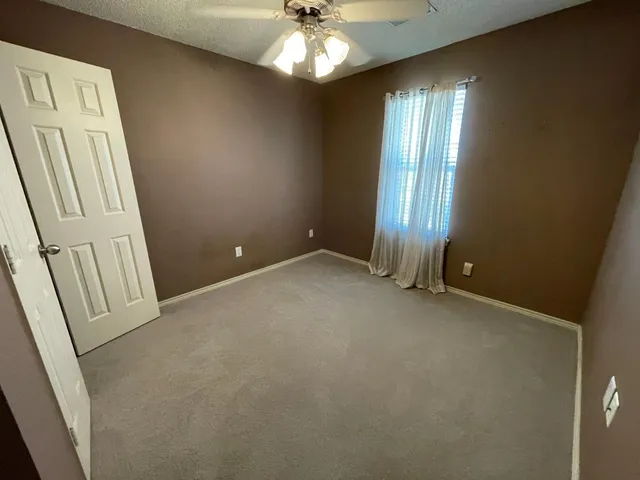 an empty room with windows and entrance