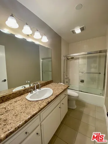 an empty room with wooden floor and fireplace