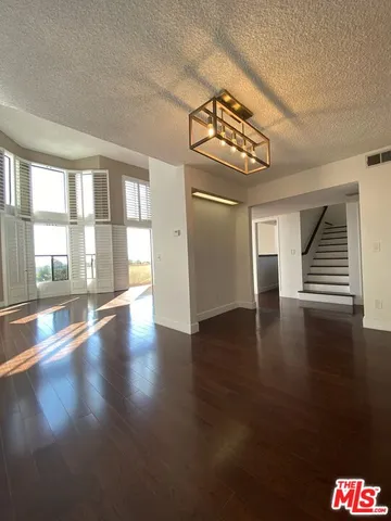 a view of kitchen with furniture and wooden floor