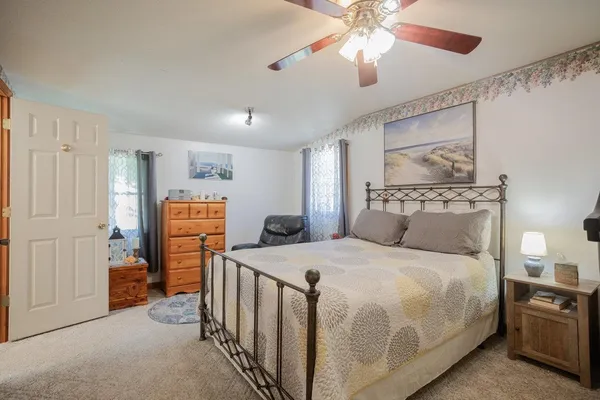 a bedroom with a bed and a chandelier