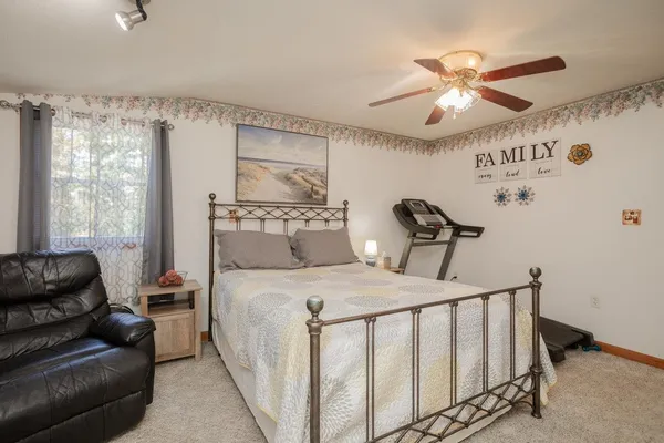 a bedroom with a bed and a dresser