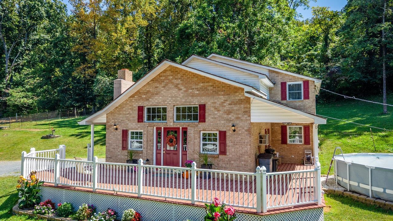 279 Helms Road Stanley, VA 22851 - Photo 54 of 64 front view of a house with a garden