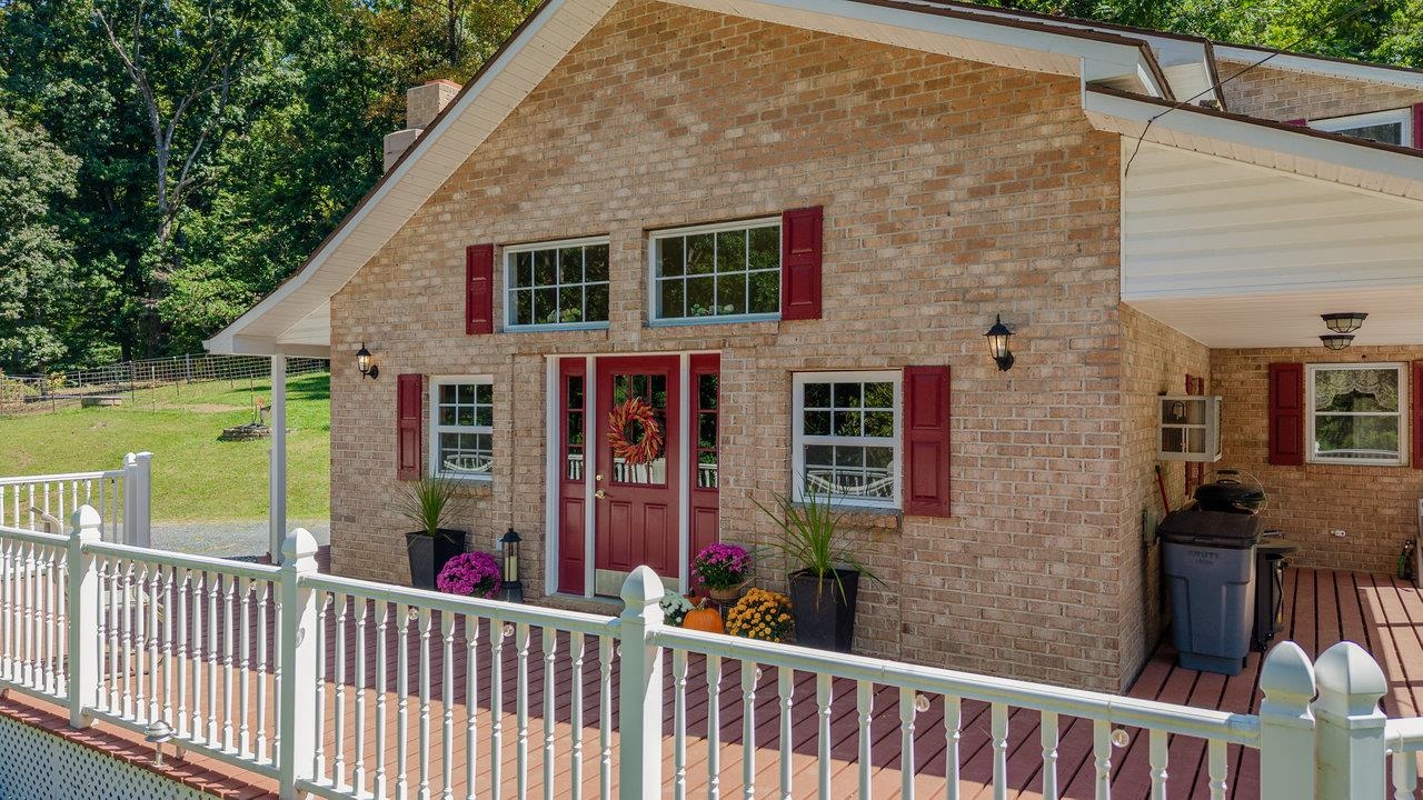 279 Helms Road Stanley, VA 22851 - Photo 58 of 64 a view of a house with a small yard and wooden fence