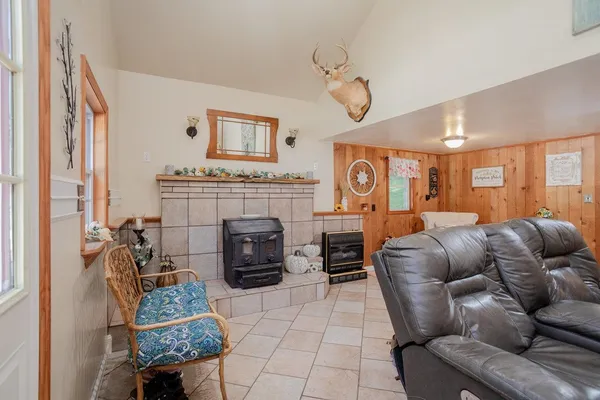 a living room with furniture a fireplace and a chandelier