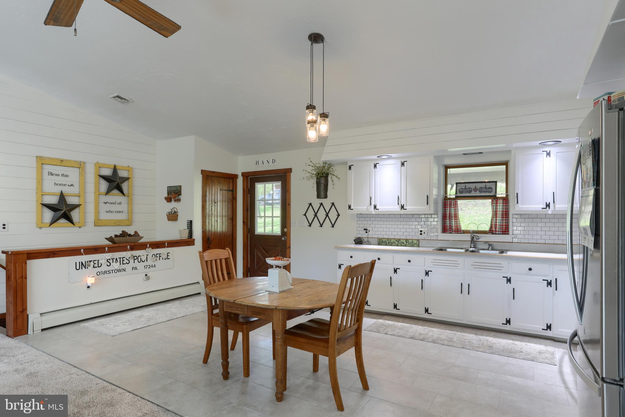 10 Bullfrog Road Grantville, PA 17028 - Photo 10 of 51 a view of a dining room and livingroom with furniture wooden floor a rug a chandelier
