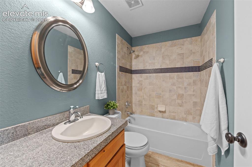 16540 Mesquite Road Peyton, CO 80831 - Photo 22 of 50 a bathroom with a sink and a mirror