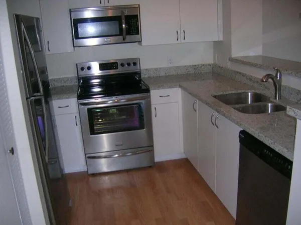 a kitchen with a stove microwave and sink