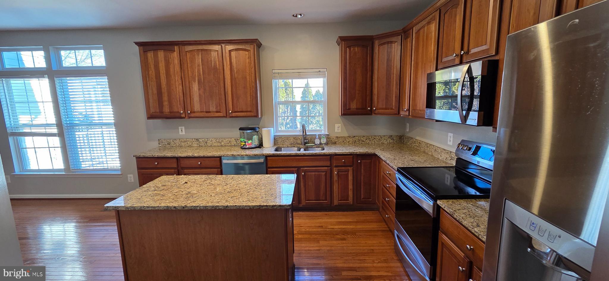 25366 Vacation Place Aldie, VA 20105 - Photo 5 of 51 a kitchen with granite countertop a sink a stove refrigerator and cabinets