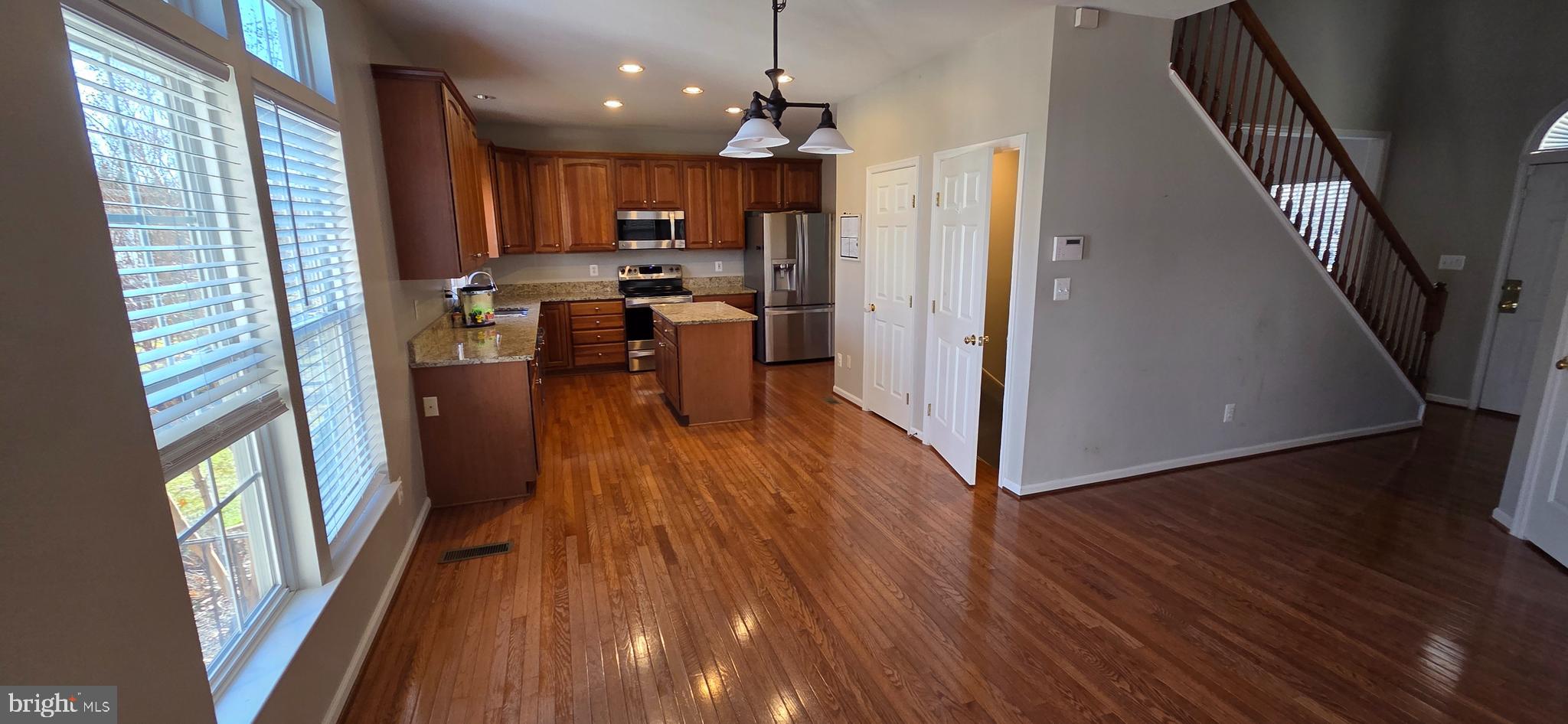 25366 Vacation Place Aldie, VA 20105 - Photo 6 of 51 a view of a kitchen with wooden floor and electronic appliances