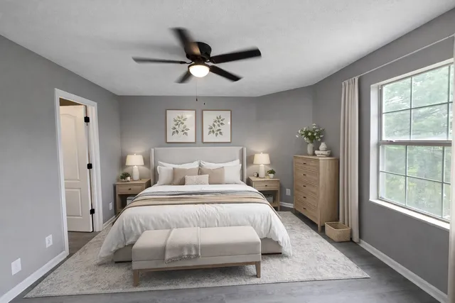 a bedroom with a large bed and a window