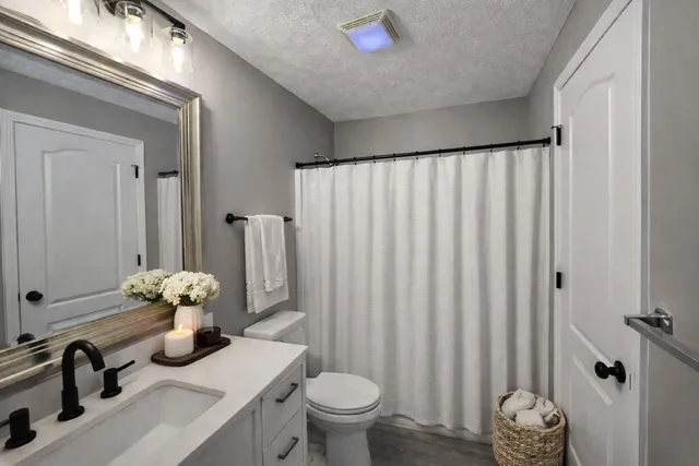 a bathroom with a sink toilet and shower