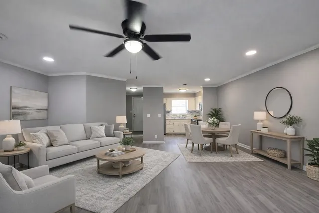 a living room with furniture and a wooden floor