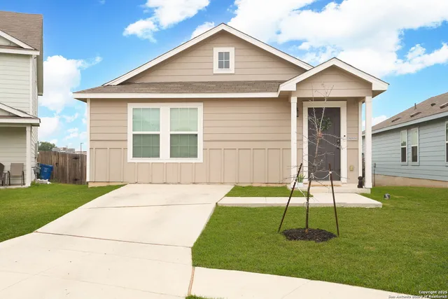 a backyard of a house with table and chairs