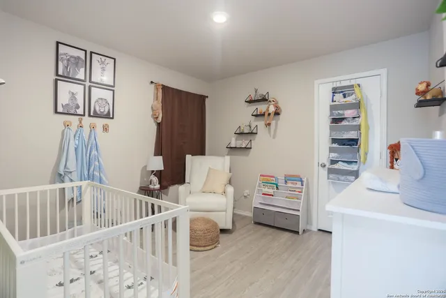 a bedroom with furniture and a wooden floor