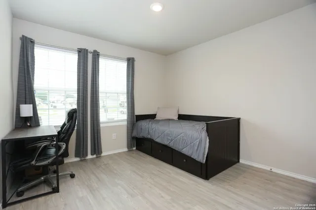 a living room with a bed furniture and a window
