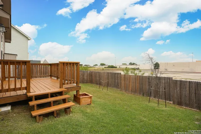 a backyard of a house with table and chairs