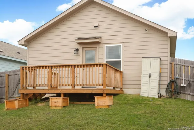 a backyard of a house with table and chairs