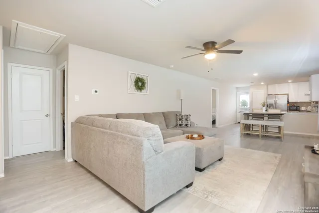 a living room with furniture and kitchen view
