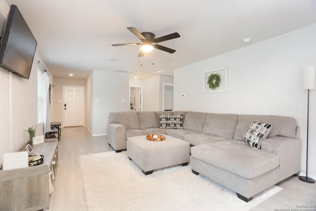 a living room with furniture and a flat screen tv