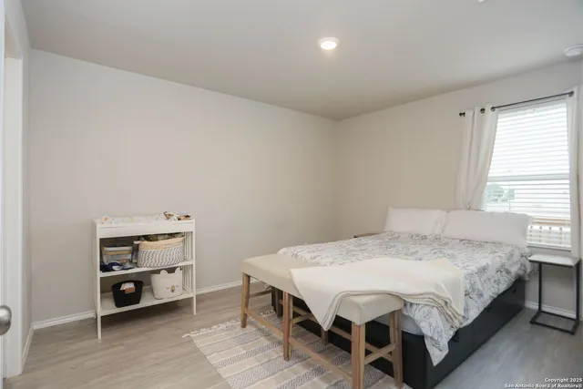 a bed sitting in a bedroom next to a window