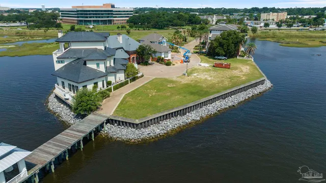 an aerial view of a house with a garden and lake view