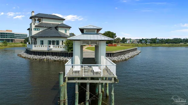 a front view of a house with lake view and a floor to ceiling window