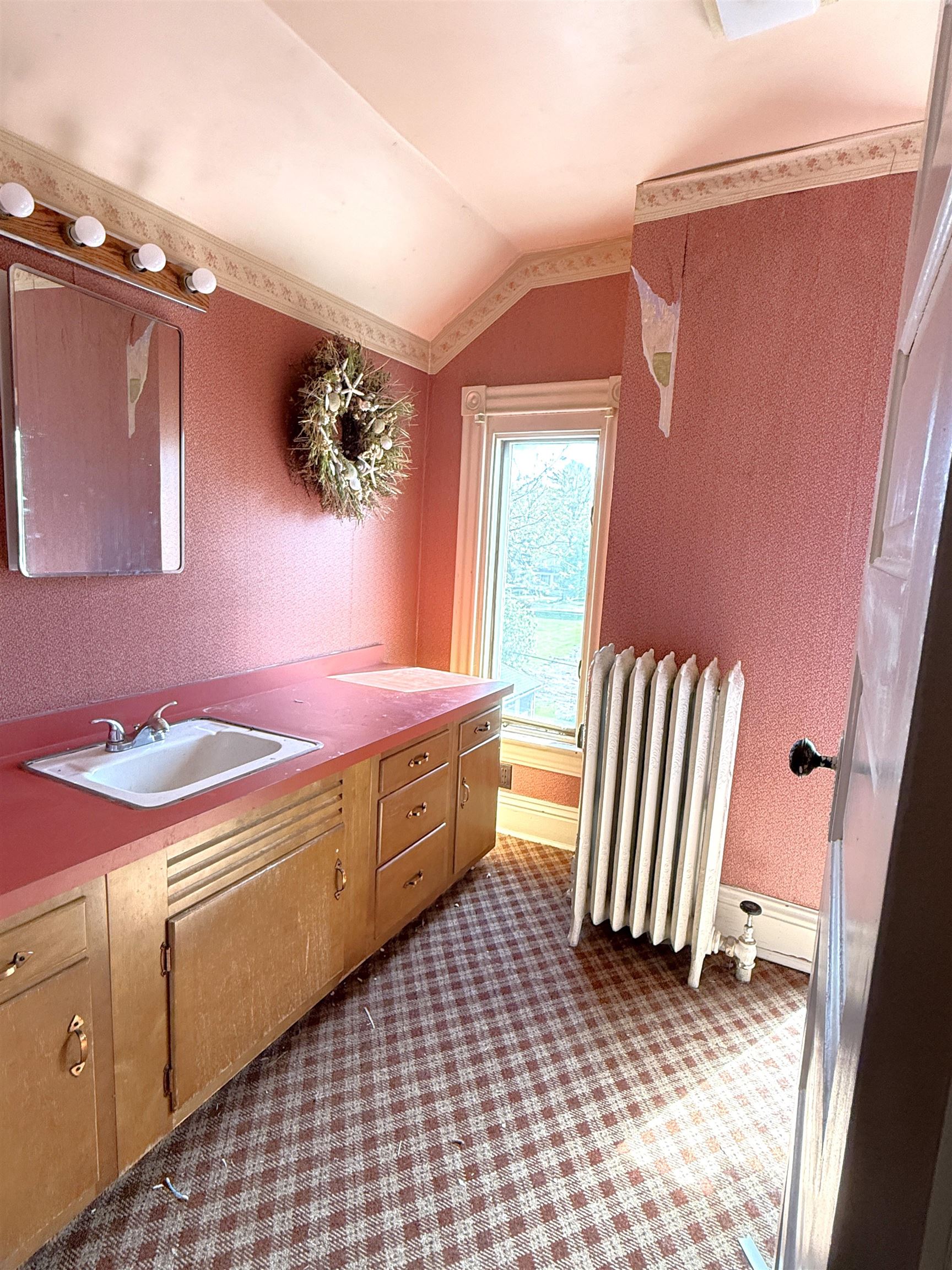 323 South Main Street Stockton, IL 61085 - Photo 18 of 32 a bathroom with a sink a mirror and a window