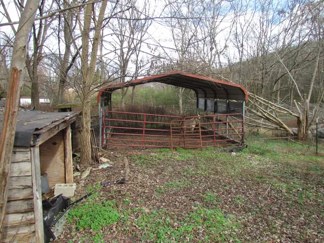 a backyard of a house with table and chairs