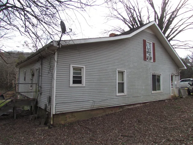 a view of a wooden house with a yard