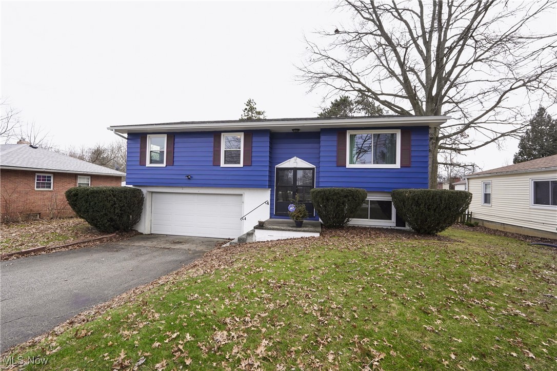 2674 Smith Road Fairlawn, OH 44333 - Photo 1 of 31 Bi-level home featuring an attached garage, a front lawn, and aphalt driveway