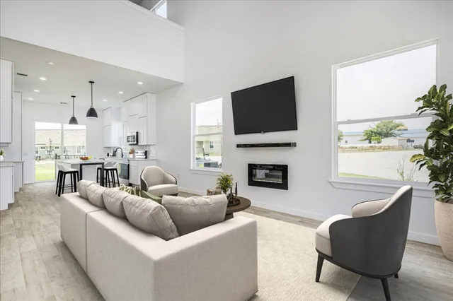a living room with furniture a fireplace and a flat screen tv