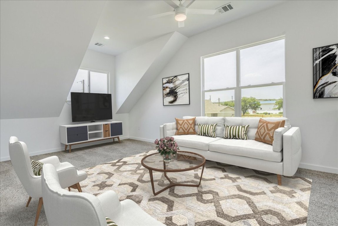 126 Lourdes Court, Unit B Dripping Springs, TX 78620 - Photo 14 of 19 a living room with furniture a flat screen tv and a large window