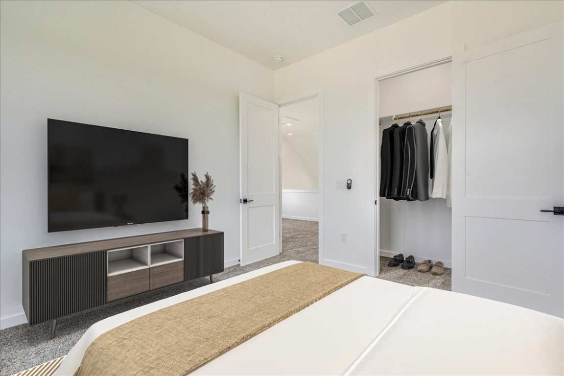 126 Lourdes Court, Unit B Dripping Springs, TX 78620 - Photo 17 of 19 a bedroom with a bed and a flat screen tv