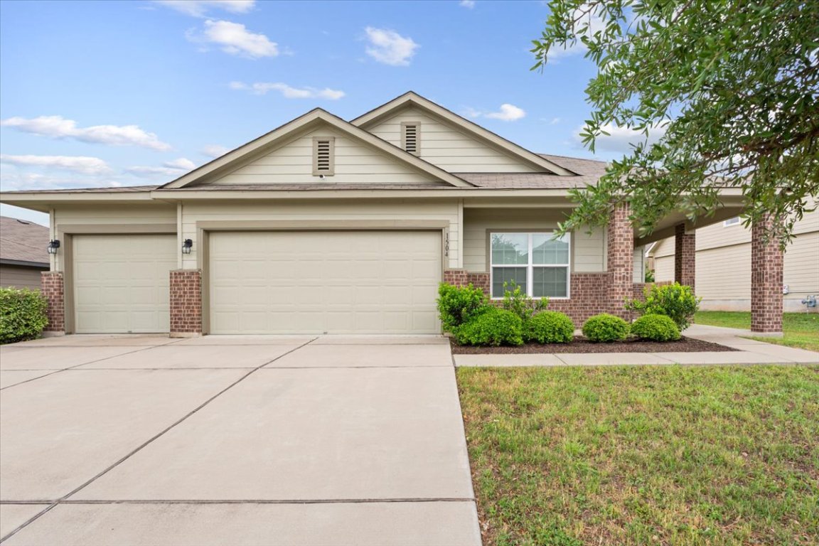 View of front of home with a 3-car garage and large front porch.