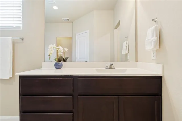 a bathroom with a sink and mirror