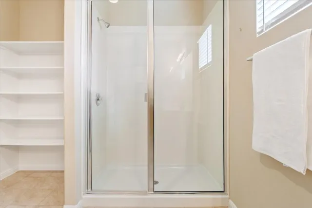 a bathroom with a glass shower door