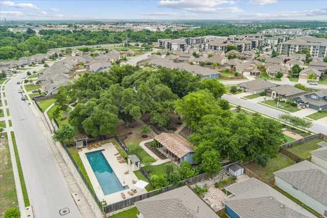 an aerial view of residential houses with outdoor space