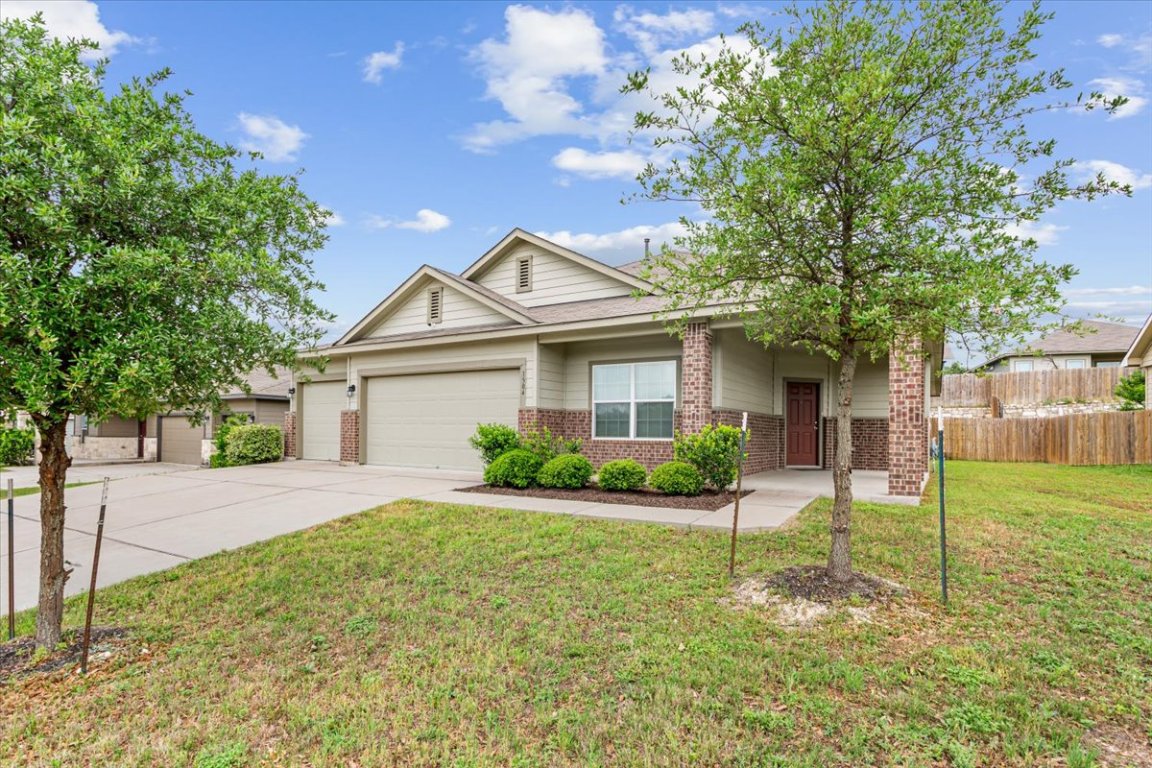 1504 Maier Drive Pflugerville, TX 78660 - Photo 31 of 31 a front view of a house with a yard and garage