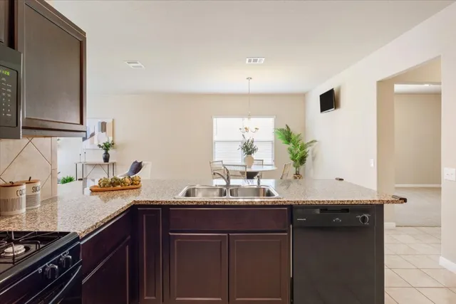 a kitchen with a sink and a stove