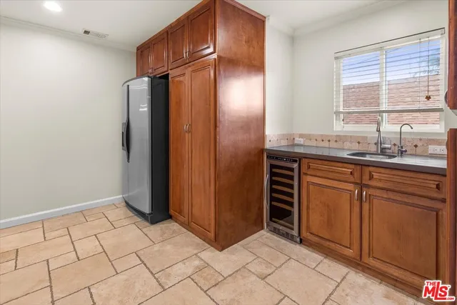 a kitchen with stainless steel appliances a refrigerator and cabinets