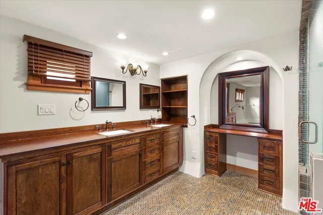a bathroom with sinks a vanity and a mirror