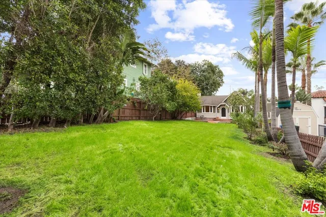 a view of a garden with a building in the background